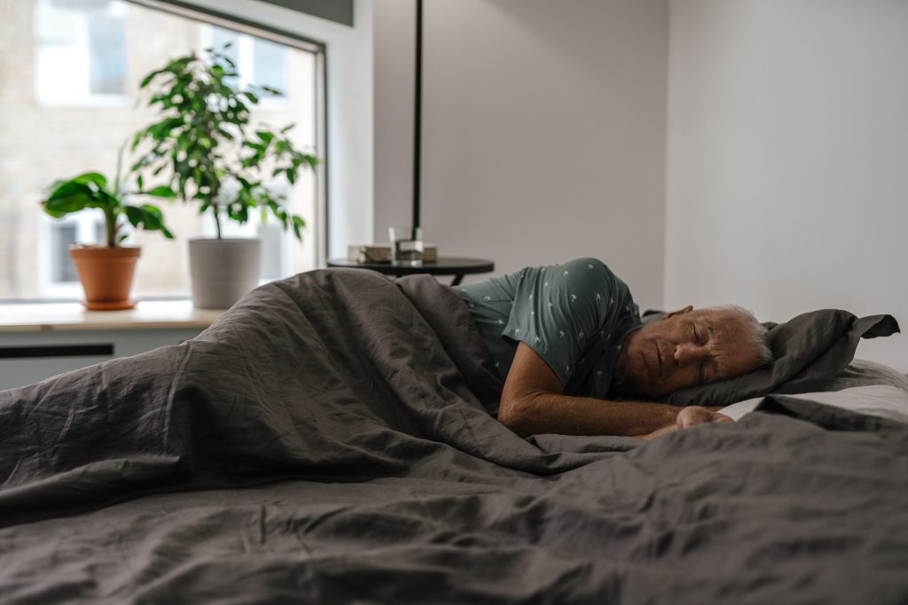 Man in green shirt sleeping