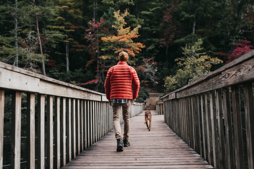 Man walking across bridge