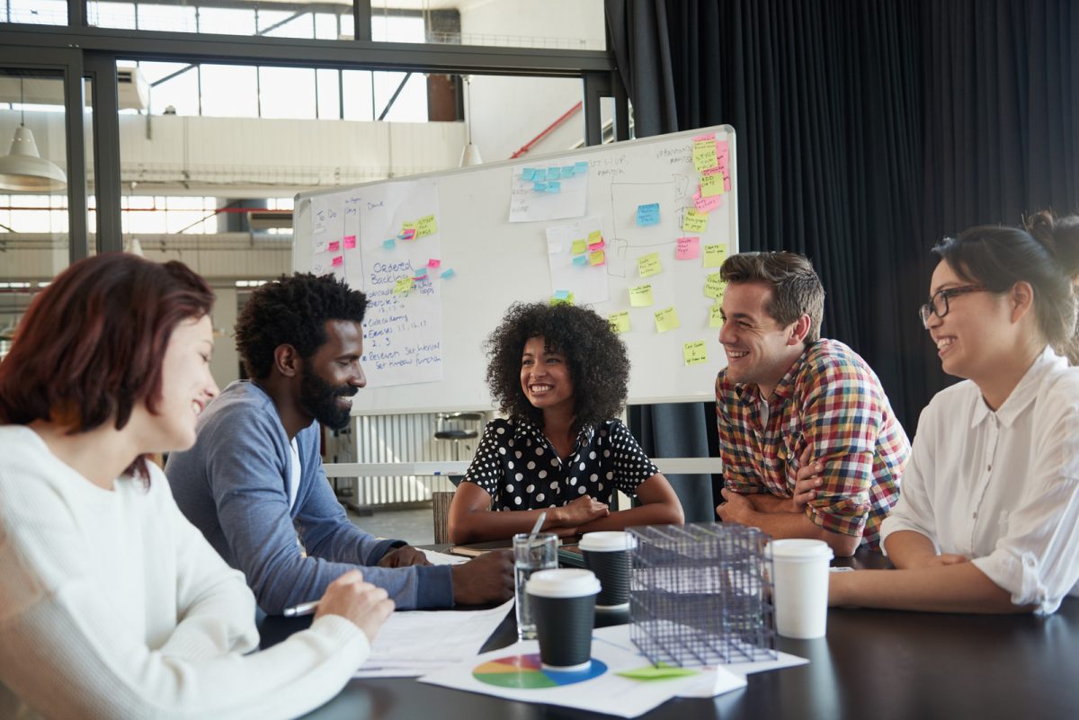 Shot of a diverse group of young business professionals having a meeting around a conference table.